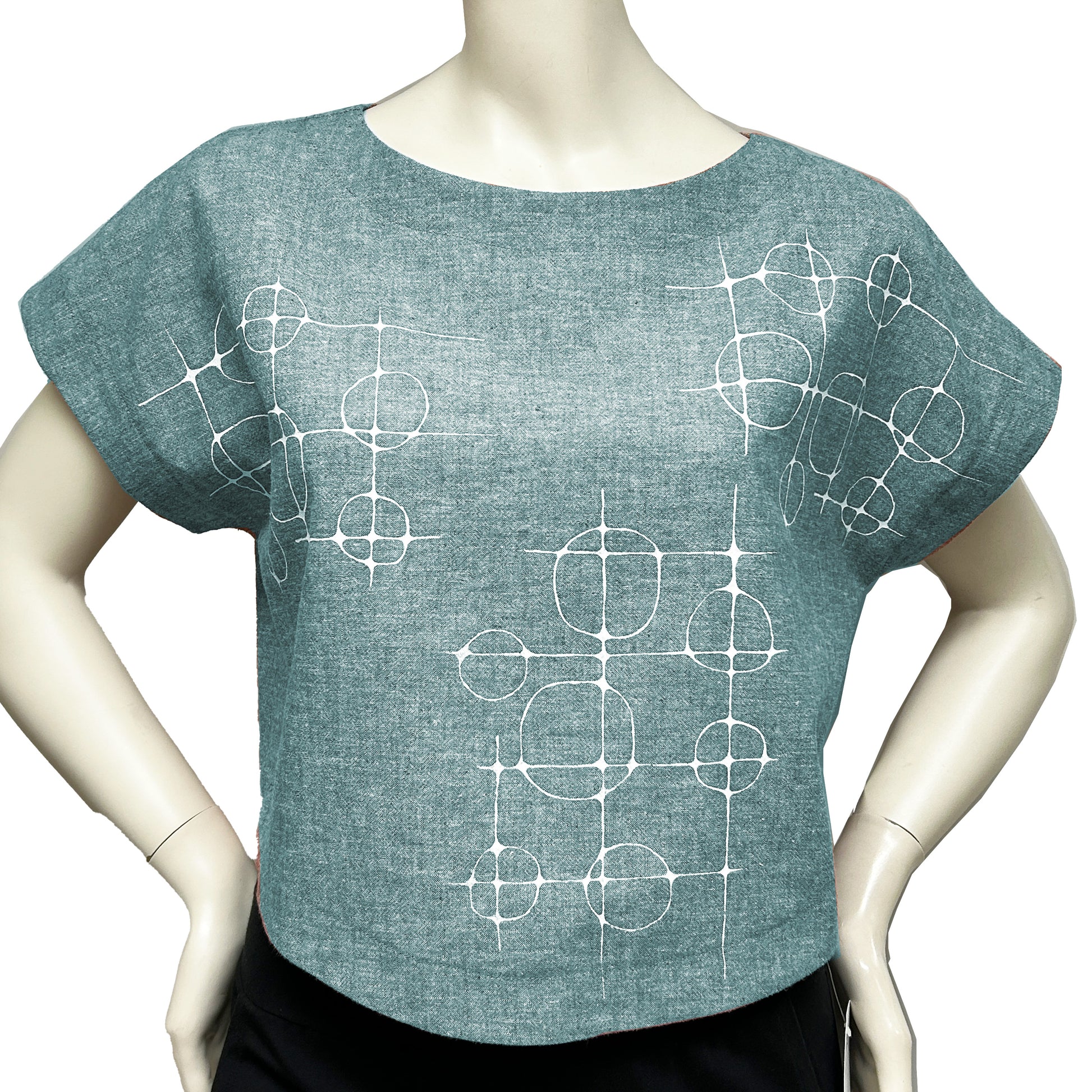 A teal hemp crop top with a hand-screened bubble and line print, displayed on a mannequin.